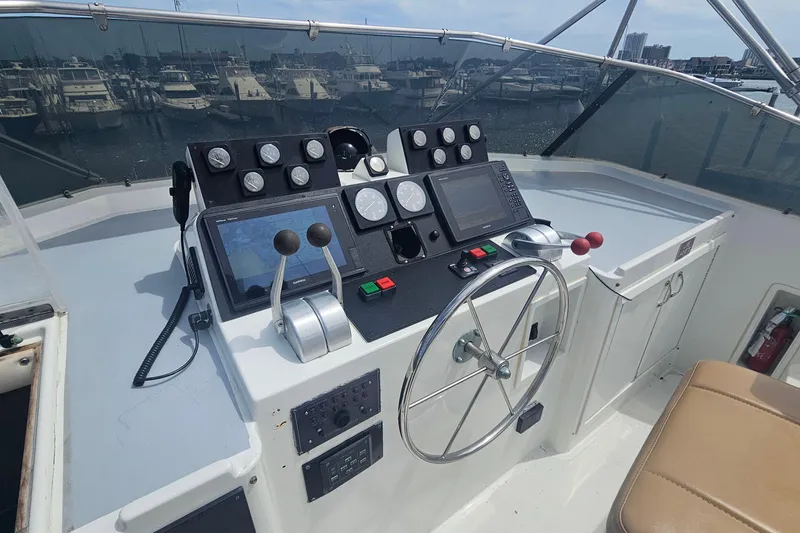 Slide: The Image of Cockpit of 1990 Hatteras 67 Cockpit Motor Yacht with navigation instruments and steering wheel. - 33