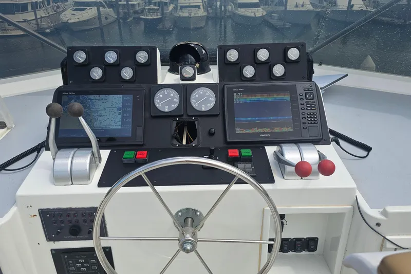 Slide: The Image of Cockpit of 1990 Hatteras 67 Cockpit Motor Yacht with navigation instruments and steering wheel. - 34