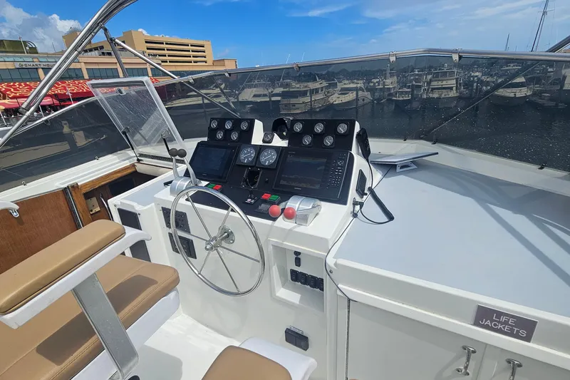 Slide: The Image of Cockpit of 1990 Hatteras 67 Cockpit Motor Yacht with steering wheel and navigation instruments. - 35