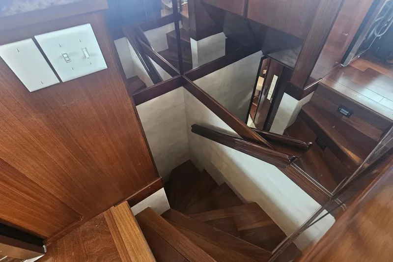 Slide: The Image of Staircase with wooden finish inside 1990 Hatteras 67 Cockpit Motor Yacht. - 41