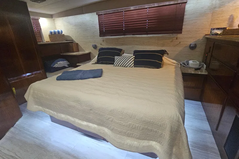 Slide: The Image of Luxurious bedroom interior of 1990 Hatteras 67 Cockpit Motor Yacht with cozy bedding. - 43