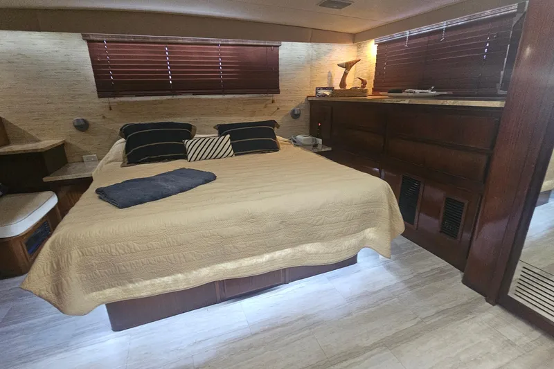 Slide: The Image of Luxurious bedroom interior of 1990 Hatteras 67 Cockpit Motor Yacht with elegant decor. - 44