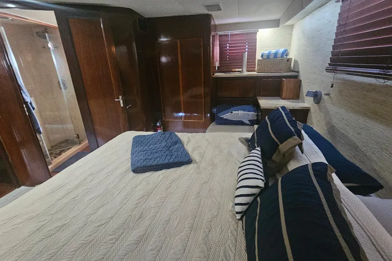 Slide: The Image of Luxurious bedroom interior of 1990 Hatteras 67 Cockpit Motor Yacht with elegant wood finishes. - 45