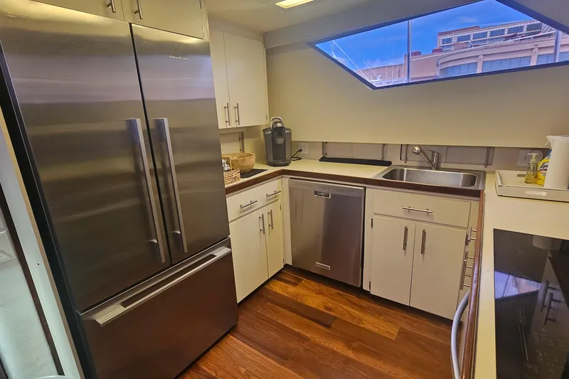 Slide: The Image of Modern kitchen in 1990 Hatteras 67 Cockpit Motor Yacht with stainless steel appliances. - 48