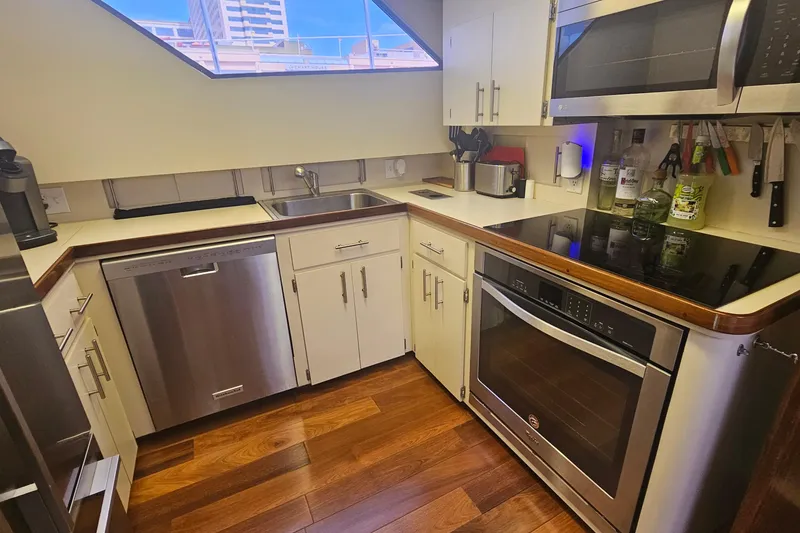 Slide: The Image of Modern kitchen in 1990 Hatteras 67 Cockpit Motor Yacht with stainless steel appliances. - 49