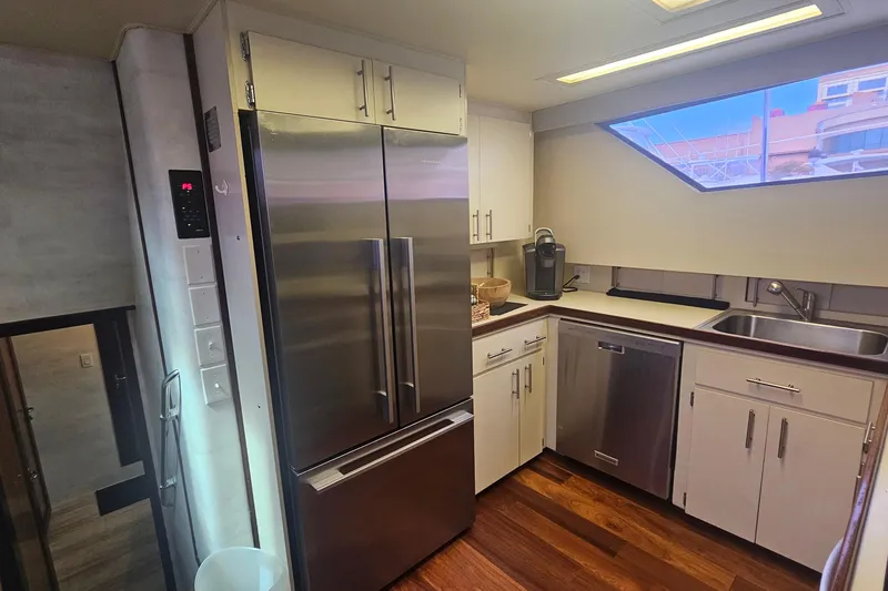 Slide: The Image of Modern kitchen interior of 1990 Hatteras 67 Cockpit Motor Yacht with stainless steel appliances. - 52