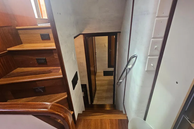 Slide: The Image of Interior staircase of 1990 Hatteras 67 Cockpit Motor Yacht with wooden steps and handrail. - 54