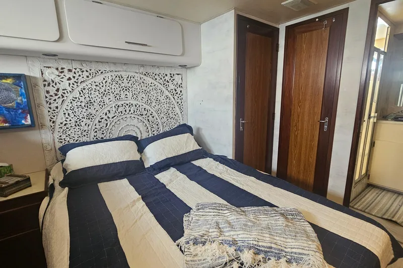 Slide: The Image of Luxurious bedroom interior of 1990 Hatteras 67 Cockpit Motor Yacht with elegant decor. - 59