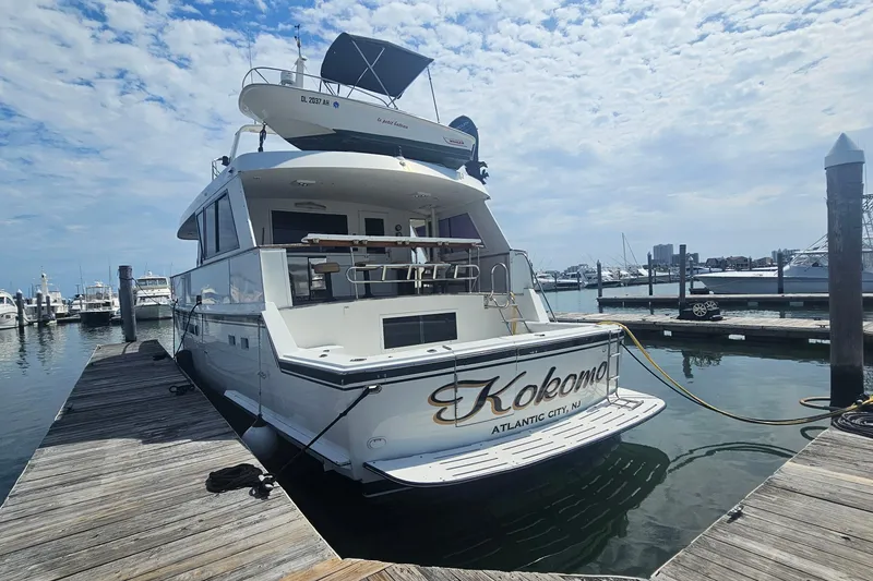 Slide: The Image of 1990 Hatteras 67 Cockpit Motor Yacht docked in marina, Atlantic City. - 6