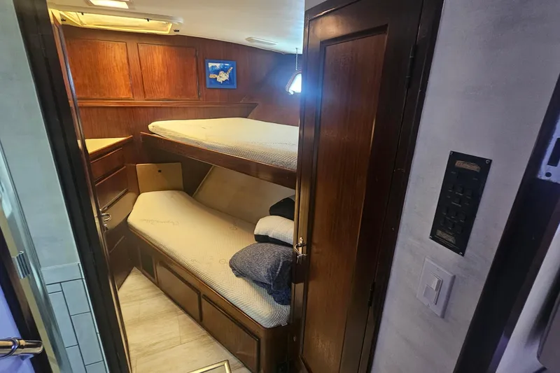 Slide: The Image of Interior cabin of 1990 Hatteras 67 Cockpit Motor Yacht with wooden bunk beds. - 60