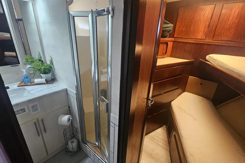 Slide: The Image of 1990 Hatteras 67 Cockpit Motor Yacht interior with bathroom and cozy cabin. - 61