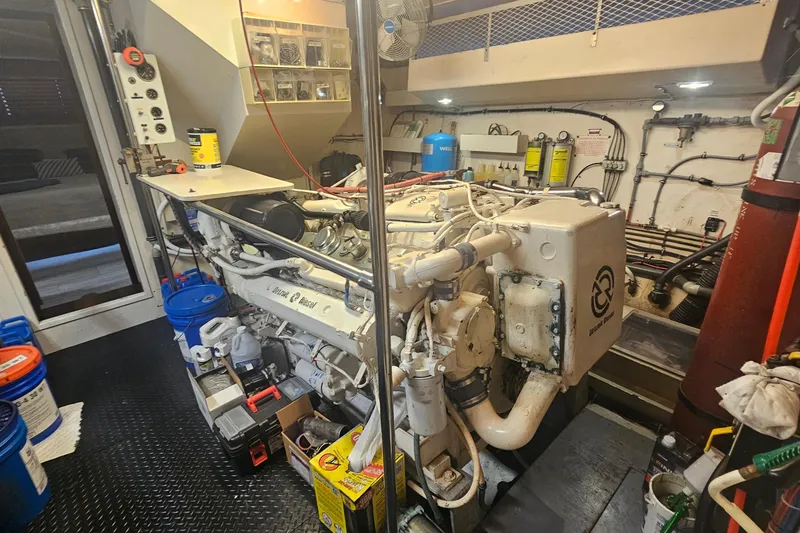 Slide: The Image of Engine room of 1990 Hatteras 67 Cockpit Motor Yacht with equipment and tools. - 63