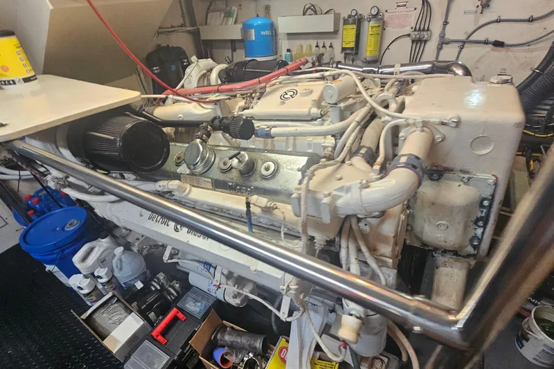 Slide: The Image of Engine room of a 1990 Hatteras 67 Cockpit Motor Yacht, showcasing machinery and components. - 65