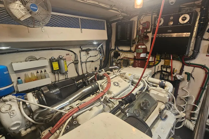 Slide: The Image of Engine room of 1990 Hatteras 67 Cockpit Motor Yacht with mechanical components. - 67