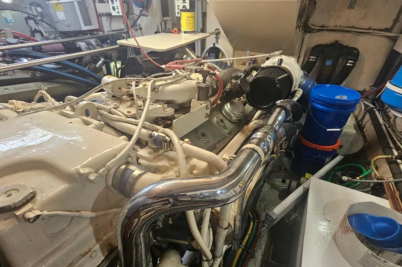 Slide: The Image of Engine room of 1990 Hatteras 67 Cockpit Motor Yacht with visible machinery and components. - 69