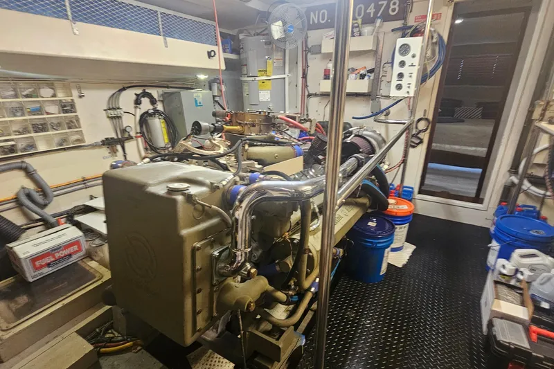 Slide: The Image of Engine room of 1990 Hatteras 67 Cockpit Motor Yacht with visible machinery and equipment. - 71