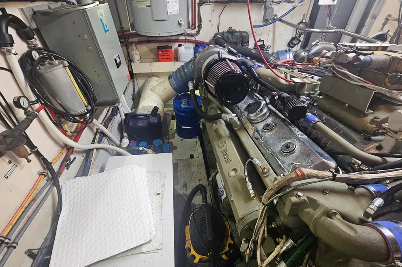 Slide: The Image of Engine room of a 1990 Hatteras 67 Cockpit Motor Yacht, showcasing machinery and components. - 72