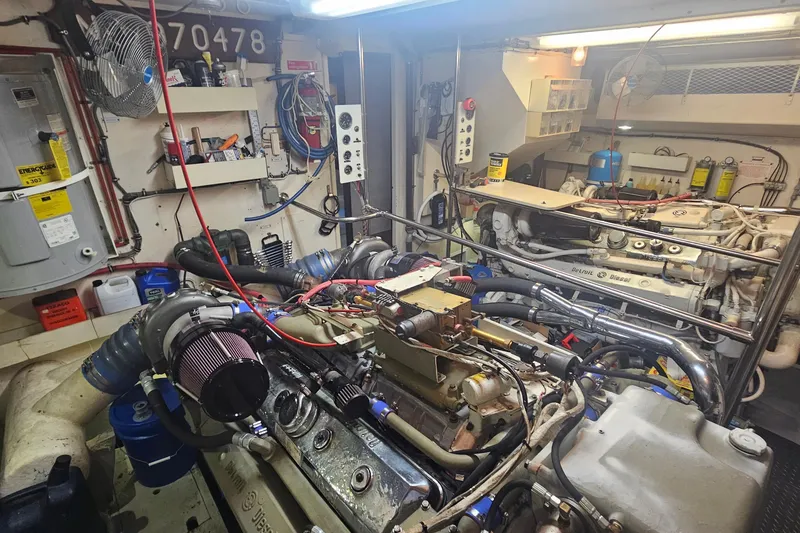 Slide: The Image of Engine room of 1990 Hatteras 67 Cockpit Motor Yacht with visible machinery and equipment. - 73