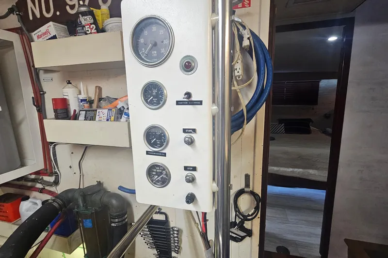 Slide: The Image of Control panel inside 1990 Hatteras 67 Cockpit Motor Yacht, featuring gauges and switches. - 76