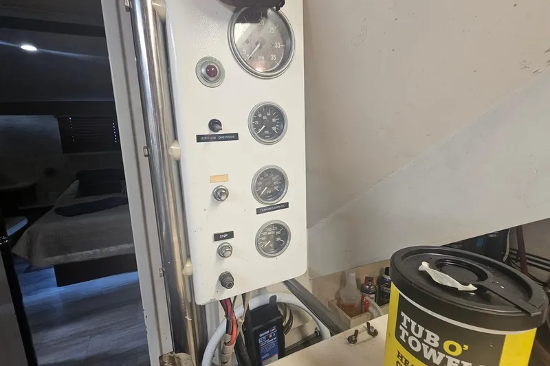 Slide: The Image of Control panel of a 1990 Hatteras 67 Cockpit Motor Yacht with gauges and switches. - 77