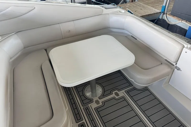 Slide: The Image of 2000 Regal Commodore 3260 boat interior with white seating and table. - 10