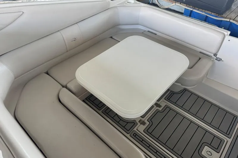 Slide: The Image of 2000 Regal Commodore 3260 boat interior with beige seating and table. - 11