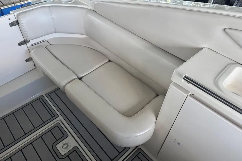 Slide: The Image of White leather seating on a 2000 Regal Commodore 3260 boat interior. - 12