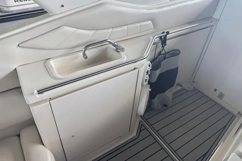 Slide: The Image of Interior of a 2000 Regal Commodore 3260 boat with sink and storage area. - 13