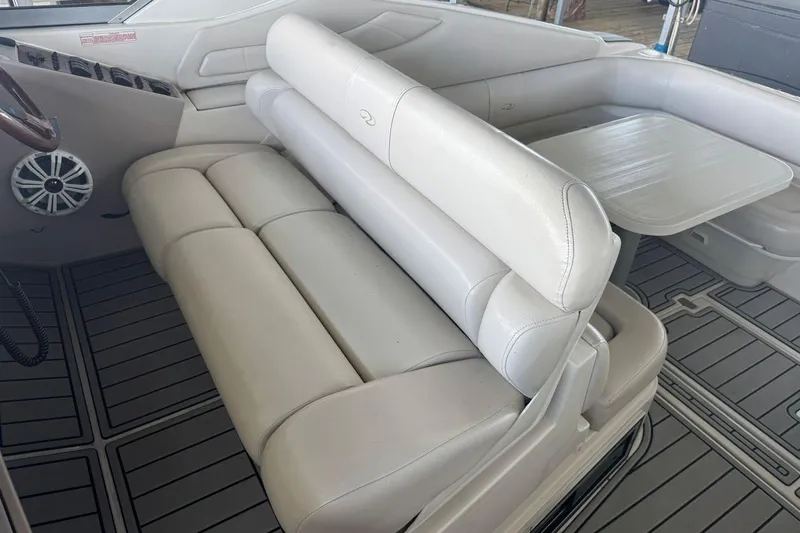 Slide: The Image of 2000 Regal Commodore 3260 boat interior with white seating and table. - 18