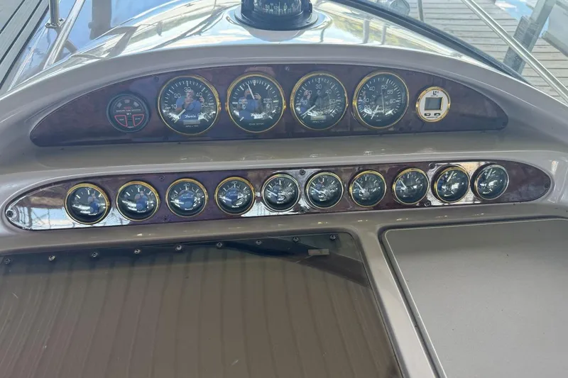 Slide: The Image of Dashboard of a 2000 Regal Commodore 3260 boat with multiple gauges and controls. - 21
