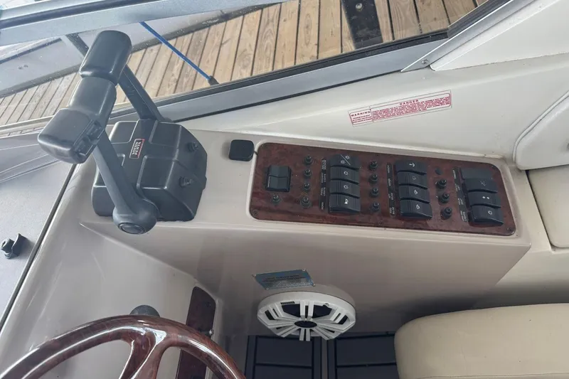 Slide: The Image of Control panel of a 2000 Regal Commodore 3260 boat with switches and throttle levers. - 22