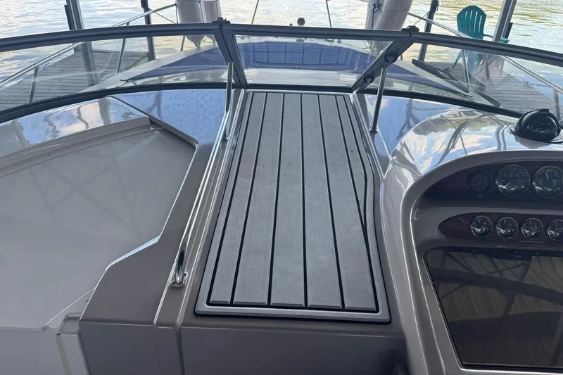 Slide: The Image of 2000 Regal Commodore 3260 boat dashboard with gauges and sleek design. - 25