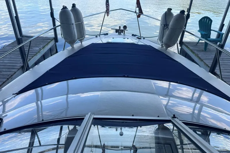 Slide: The Image of 2000 Regal Commodore 3260 yacht docked, featuring a sleek deck and water view. - 26