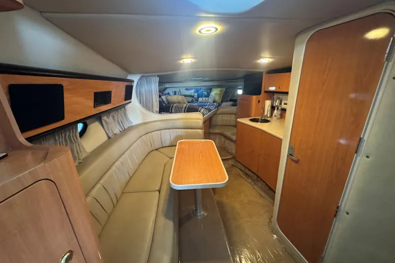 Slide: The Image of Interior of 2000 Regal Commodore 3260 yacht with seating, table, and kitchenette. - 31