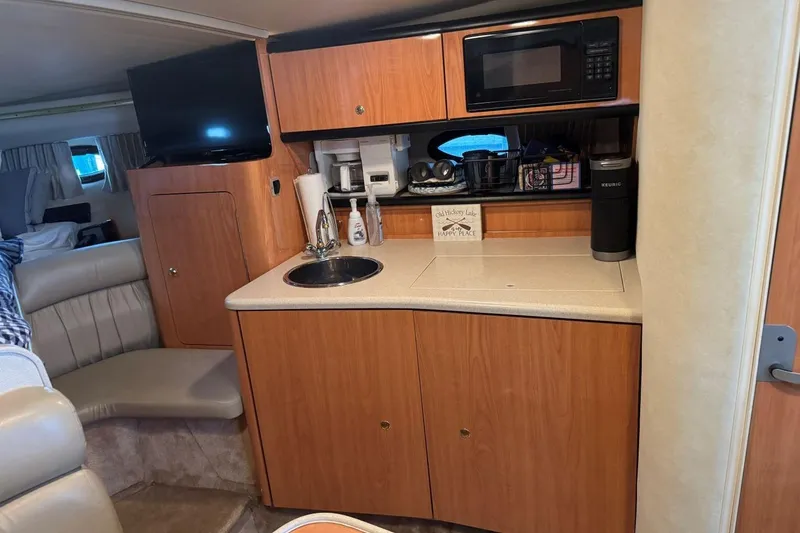 Slide: The Image of Interior of 2000 Regal Commodore 3260 yacht with kitchenette and seating area. - 36