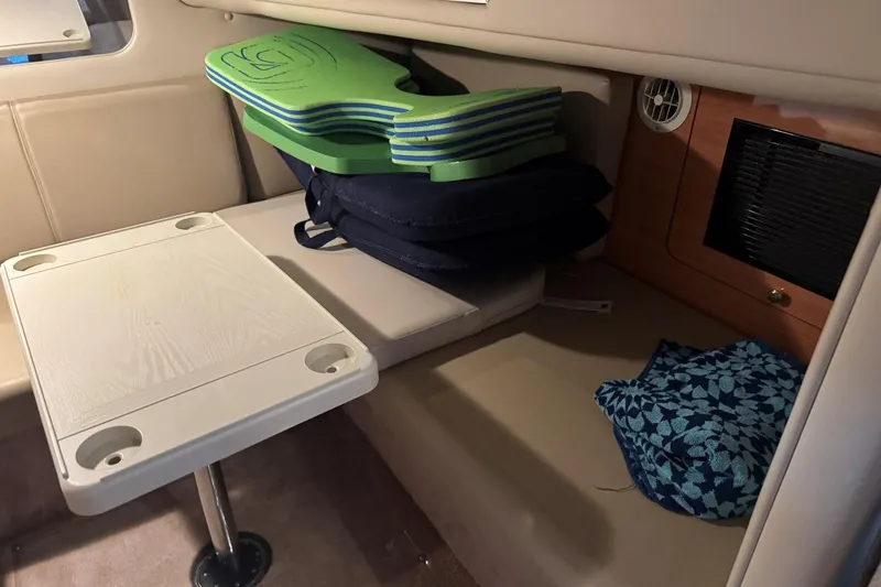 Slide: The Image of Interior of 2000 Regal Commodore 3260 boat with table and seating area. - 41