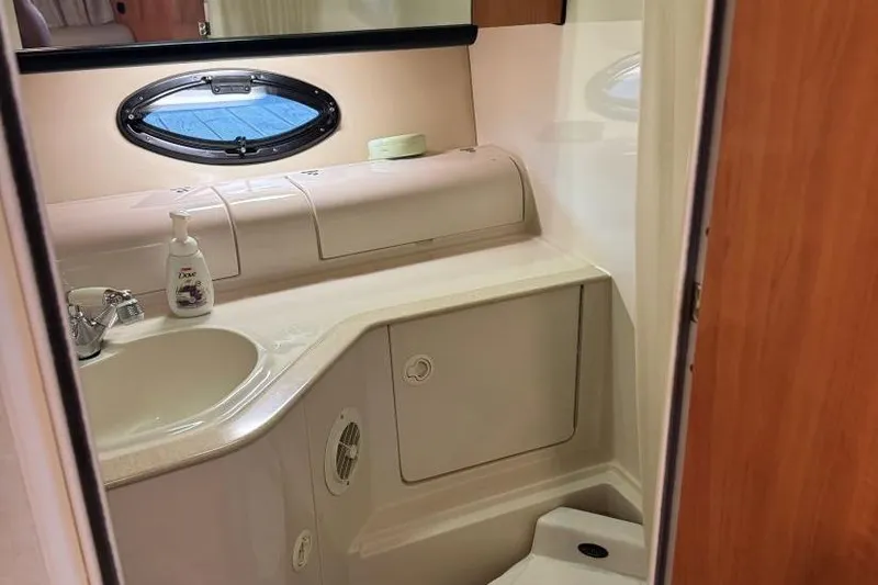 Slide: The Image of Bathroom interior of 2000 Regal Commodore 3260 yacht, featuring sink and porthole window. - 42