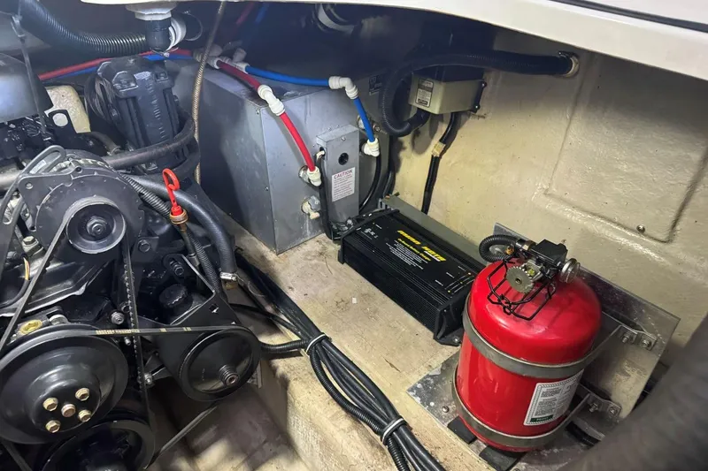Slide: The Image of Engine compartment of 2000 Regal Commodore 3260 with fire extinguisher and wiring. - 44