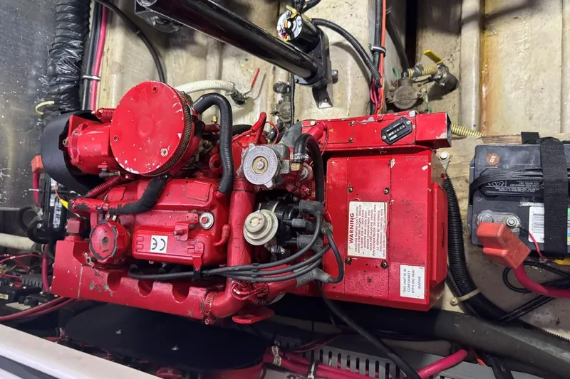 Slide: The Image of Red engine of a 2000 Regal Commodore 3260 boat, with visible wiring and components. - 47