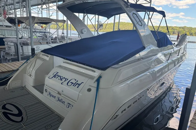 Slide: The Image of 2000 Regal Commodore 3260 boat named "Jersey Girl" docked at a marina. - 53