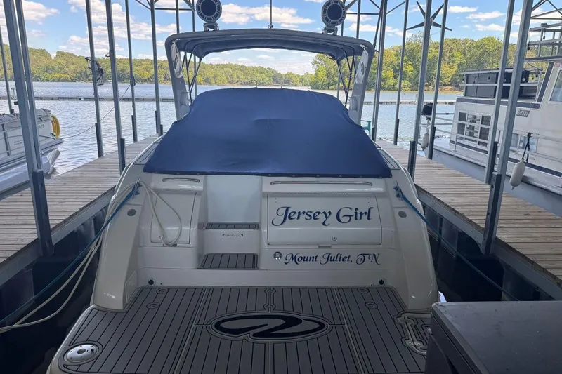 Slide: The Image of 2000 Regal Commodore 3260 boat named "Jersey Girl" docked at a marina. - 54