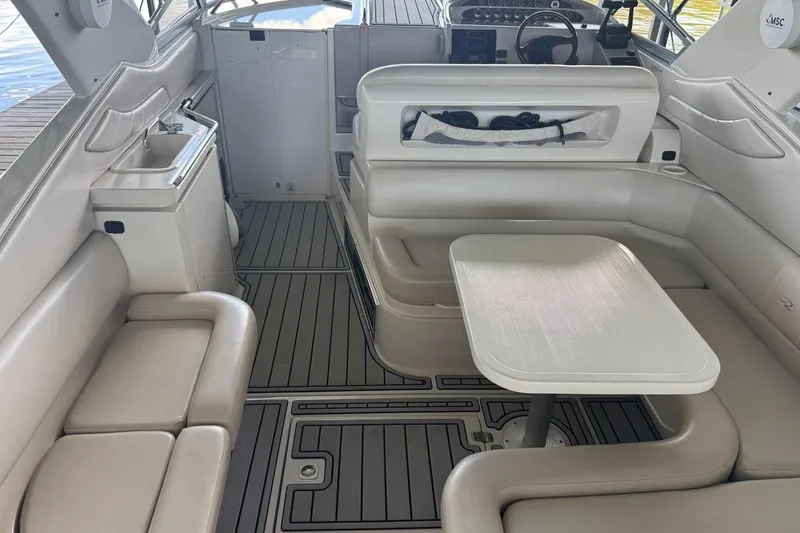 Slide: The Image of Interior of a 2000 Regal Commodore 3260 boat with seating and table. - 9