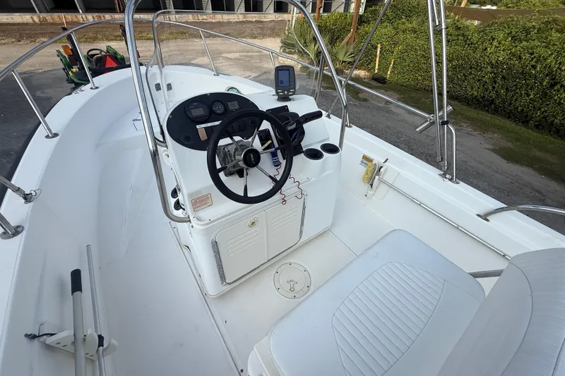 Slide: The Image of 2002 Boston Whaler 180 Dauntless boat interior with steering console and seating. - 14