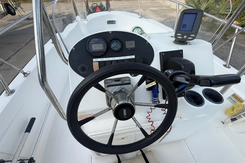 Slide: The Image of Steering console of a 2002 Boston Whaler 180 Dauntless boat with gauges and controls. - 15