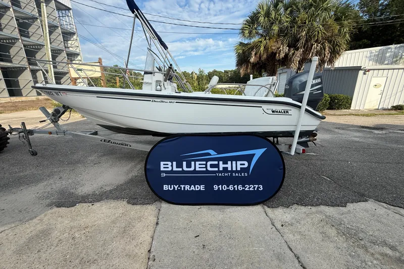 Slide: The Image of 2002 Boston Whaler 180 Dauntless boat on trailer, displayed by Blue Chip Yacht Sales. - 19
