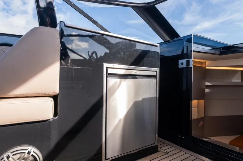 Slide: The Image of Interior of 2025 Colnago C38 OPEN yacht with sleek black and beige design. - 22