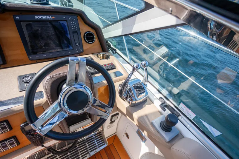 Slide: The Image of Cockpit of 2018 Cobalt 46 Yacht with steering wheel and navigation system. - 14