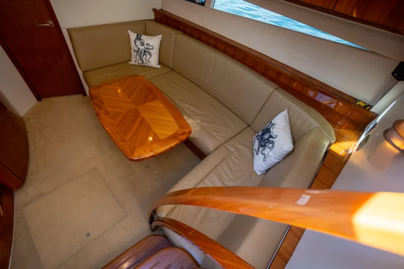 Slide: The Image of Luxurious interior of 2018 Cobalt 46 Yacht with elegant seating and wooden table. - 16