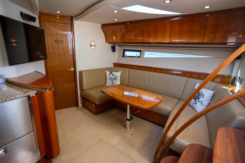 Slide: The Image of Luxurious interior of 2018 Cobalt 46 Yacht with elegant wood finishes and plush seating. - 17