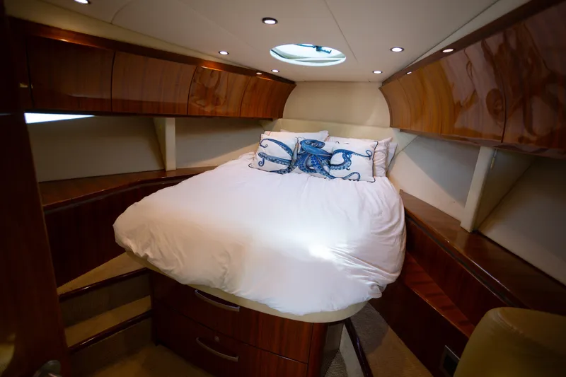 Slide: The Image of Luxurious 2018 Cobalt 46 Yacht cabin with elegant wood finish and cozy bedding. - 21
